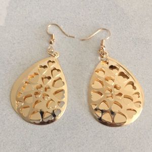Dangle earrings. Gold in color.